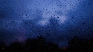 rain days, heavy rain falling on window surface, evening, the colors go out video