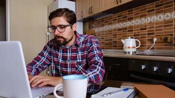 Focused business man entrepreneur typing on laptop doing research. Young male professional using computer sitting at home office desk. Busy worker freelancer working on modern tech notebook device. video