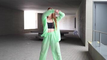 A captivating urban dance performance set against a backdrop of concrete architecture video