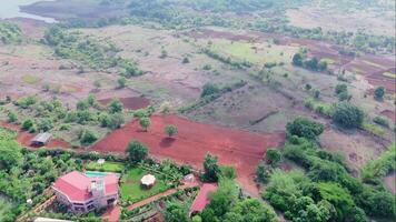Village featuring mix of greenery and farmland video