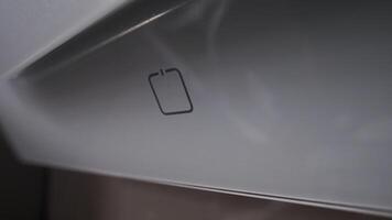 Home life. Close-up of hand selecting mode on touch panel of hood. Cropped shot of hand pressing button on touch display setting power of modern hood video