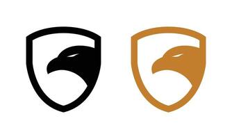 two eagle heads on a shield, one black and one gold. Eagle head and shield logo emblem design vector