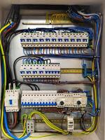 Fuse box, control panel with many various wires and fuses, electrical control panel enclosure for power and distribution electricity on the building site. photo