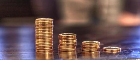 Coins stack in front. Savings money of coins concept for saving or investment for a house. Finance concept. photo