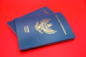 2 green indonesian passports isolated on red background photo