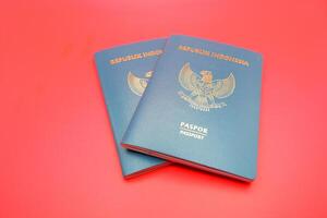 2 green indonesian passports isolated on red background photo