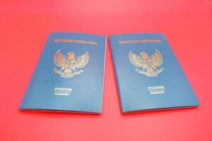 2 green indonesian passports isolated on red background photo