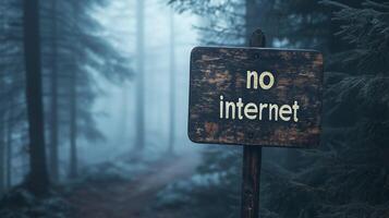 No Internet sign or warning in the middle of deep misty, foggy forest. Concept of digital disconnect, digital detox, offline adventure. photo