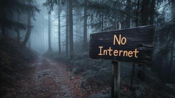 No Internet sign written in the woods in the middle of deep forest path. No internet signal warning, wilderness. photo