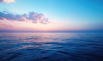 The ocean is calm and the sky is a beautiful shade of blue photo