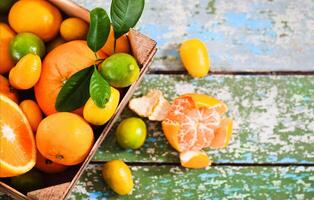 Fresh citrus fruits in the wooden box photo