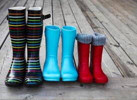 Three pairs of a colorful rain boots photo