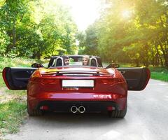 Happy couple in red cabriolet photo
