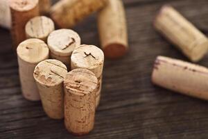 Dated wine bottle corks on the wooden background photo