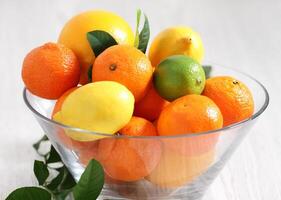 Fresh citrus fruits in the vase photo