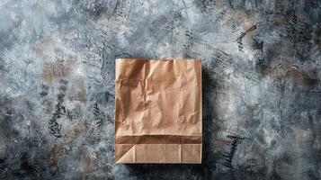 Crumpled paper bag mockup on rough concrete surface. Rugged backdrop, simplicity of paperbag template advertising image. Eco-friendly packaging mock up product photorealistic photo