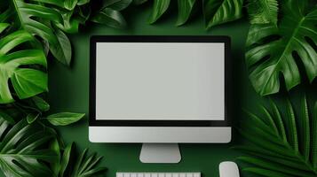 Modern monitor mockup in tropical leaves frame. Exotic jungle plants and computer monitor template advertising image. Productive workplace with screen mock up product photorealistic photo