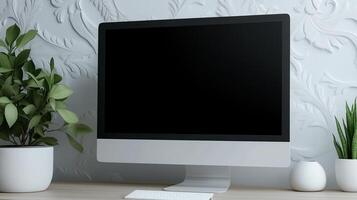 Computer monitor mockup near wall with floral patterns. Office workplace arrangement with pc template advertising image. Device screen mock up on table product photorealistic photo
