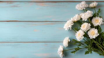 Chrysanthemums bouquet on blue wooden table banner background copy space. Fresh flowers on rustic desk image backdrop empty. Floral design concept composition top view, copyspace photo