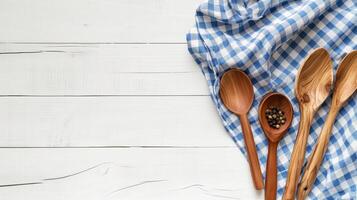 Handmade spoons and towel on table banner background copy space. Vintage kitchen utensils on wooden desk image backdrop empty. Kitchenware concept composition top view, copyspace photo