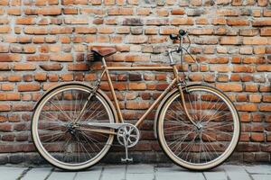 Vintage bicycle leaning against a textured brick wall in an urban setting during daylight photo