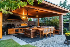 Outdoor kitchen and dining area under a covered patio surrounded by greenery in the evening photo