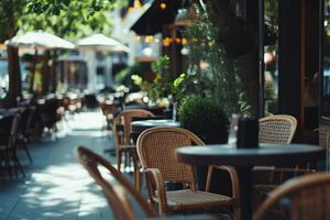 Outdoor dining area with wicker chairs and plants in a sunlit urban setting photo