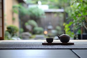 Elegant tea set on a wooden tray with serene Japanese garden visible in the background photo