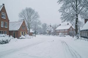 Snow-covered residential street in a quiet town during winter weather photo