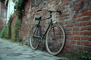 Classic bicycle leaning against a rustic brick wall on a quiet cobblestone path in the evening photo