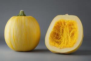 Yellow spaghetti squash whole and halved showcasing its unique interior and vibrant color photo