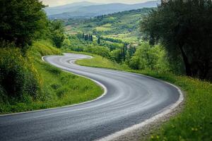 Winding road through lush green hills in Tuscany under a cloudy sky photo
