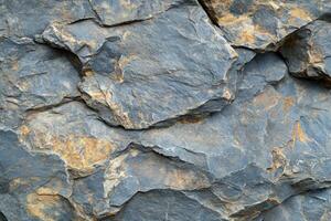 Natural slate rock texture with layers and earthy tones found in a serene outdoor environment photo