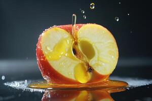 Juicy red apple sliced in half with honey dripping on a black background photo
