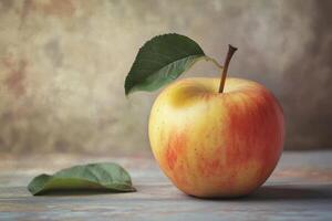 Fresh red apple with green leaf rests on a rustic wooden surface in soft natural light photo