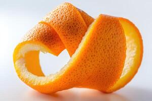 Curled orange peel spiraling in bright light against a clean backdrop in a minimalist style photo