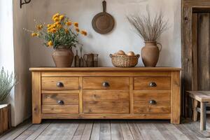 Rustic wooden sideboard adorned with pottery and wildflowers in a cozy kitchen setting photo