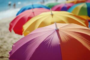 Colorful beach umbrellas line the sandy shore under a bright sun in summer photo