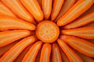 Freshly cut carrots arranged in a circular pattern to resemble a flower on a neutral background photo