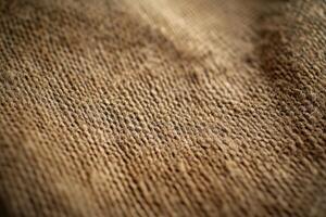 Close-up view of textured burlap fabric showcasing its natural fibers and weave detail photo