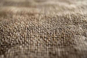 Close-up view of textured burlap fabric showing intricate weave patterns in natural light photo