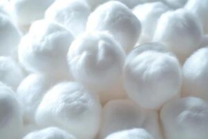Close-up of fluffy cotton balls arranged neatly on a white surface creating a soft texture photo