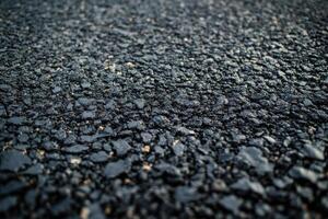 Close-up view of textured asphalt surface during daylight showcasing road construction details photo