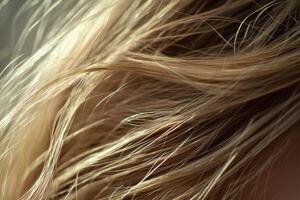 Close-up view of sunlit blonde hair with gentle strands illuminated in natural light photo