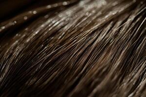 Close-up view of shiny brown hair strands illuminated in soft light photo