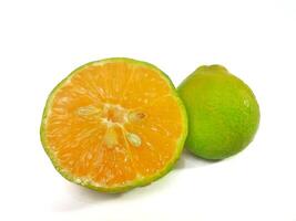 Lemon and slice isolated on white background. orange peel is green photo