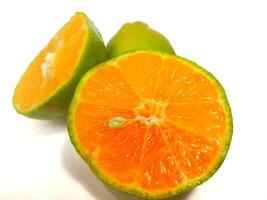 Lemon and slice isolated on white background. orange peel is green photo