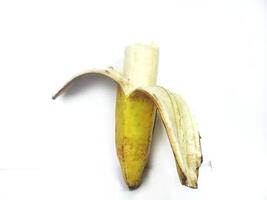 Half banana insulated. Ripe yellow banana on a white background. Fresh fruit with copy space. eat half photo