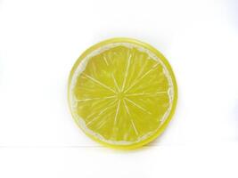 Lemon isolated. Round slice of ripe lemon on a white background. Fresh fruits with copy space photo