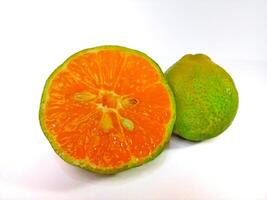Lemon and slice isolated on white background. orange peel is green photo